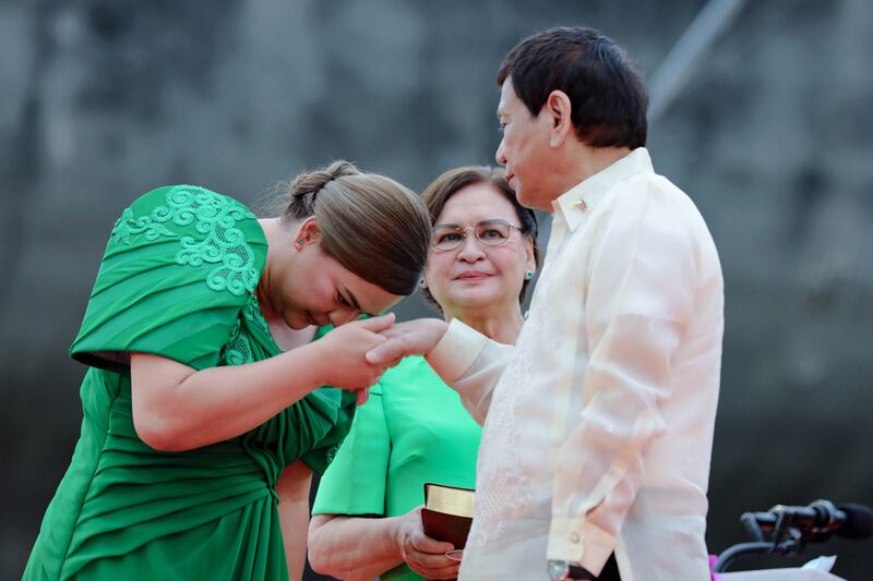 Philippines Vice President Sara Duterte greets her father, outgoing president Rodrigo Duterte, and her mother, Elizabeth Zimmerman, during her inauguration ceremony in Davao City in June 2022. EPA