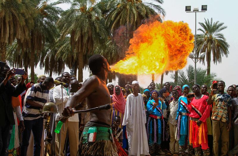 A Sudanese fire-breather performs at a rally in Khartoum in support of political talks called for by army chief Abdel Fattah Al Burhan, who led last year's military takeover. All pictures: AFP