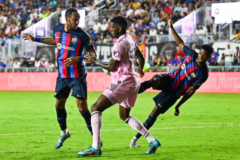 Barcelona forward Pierre-Emerick Aubameyang, Inter Miami defender Damion Lowe and Barcelona forward Ansu Fati in action during a friendly match against Inter Miami. AFP