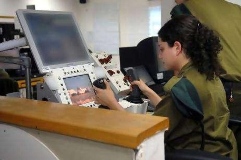 An unidentified Israeli soldier operates "Spot and Shoot", a system that allows her to fire a remotely controlled machine-gun to execute Palestinians who approach the fence around Gaza by pressing a button on her joystick. Israel is at the forefront of developing such "remote killing" technology. (copyright: Israel Defence Forces) To go with Jonathan Cook story for Foreign