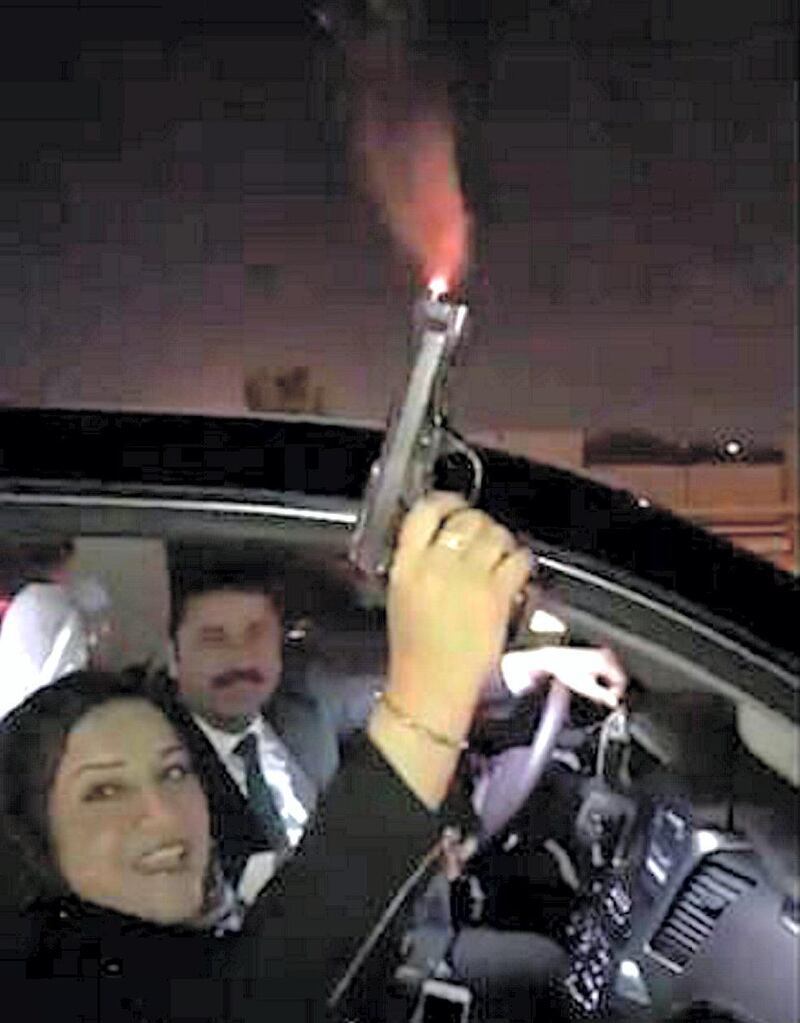 A screen grab of Iraqi member of parliament Wihda Al Jumaily firing gun into the sky. Twitter 