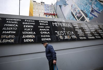 A man walks past a banner reading 'memory and justice' and the names of the victims of the 1994 bombing attack in Buenos Aires, Argentina. Reuters