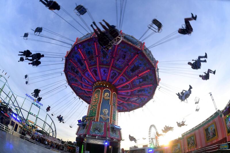 People enjoy a ride on a merry-go-round at the Oktoberfest festival in Munich, Germany. Felix Hoerhager/AP Photo