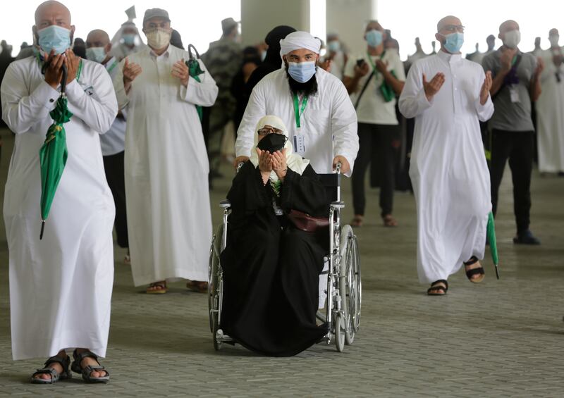 Pilgrims at prayer after participating in the symbolic stoning of the devil during the Hajj pilgrimage in Mina, Saudi Arabia.