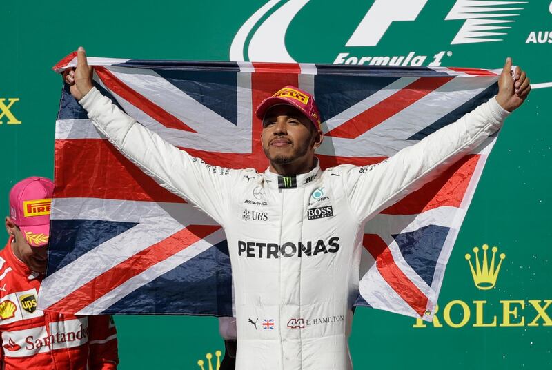 Mercedes driver Lewis Hamilton, of Britain, celebrates after winning the Formula One U.S. Grand Prix auto race at the Circuit of the Americas, Sunday, Oct. 22, 2017, in Austin, Texas. (AP Photo/Eric Gay)