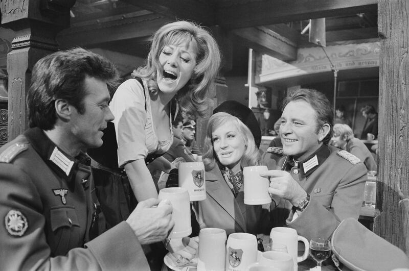 Actors Clint Eastwood as 'Lt Morris Schaffer', Mary Ure (1933 - 1975) as 'Mary Ellison', Ingrid Pitt (1937 - 2010) as 'Heidi Schmidt', Richard Burton (1925 - 1984) as 'Maj John Smith' on the set of British World War II action film 'Where Eagles Dare', 17th February 1968. (Photo by David Cairns/Daily Express/Getty Images)