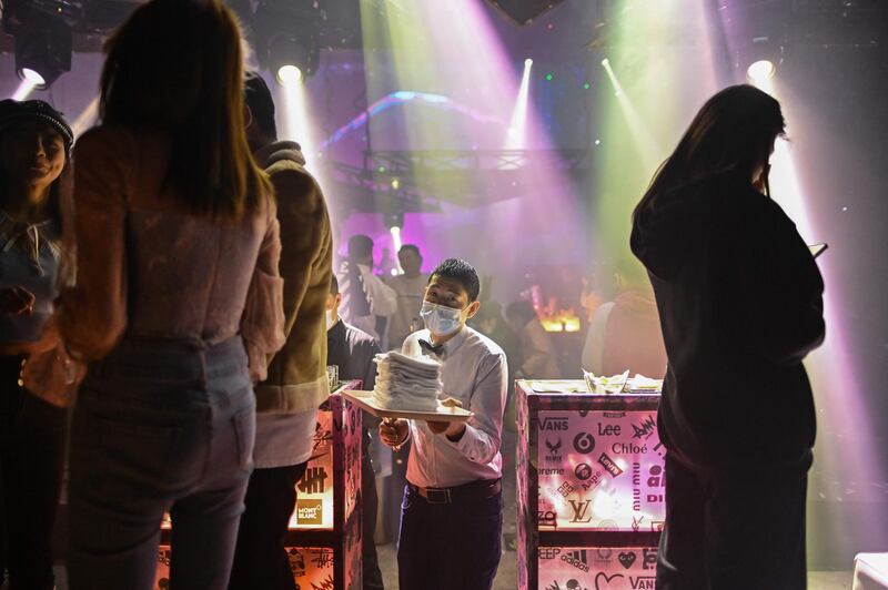 A staff member attends to patrons at a nightclub in Wuhan. AFP