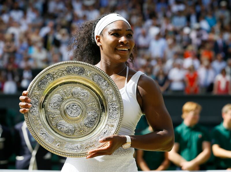 FILE - Serena Williams holds up the trophy after winning the women's singles final against Garbine Muguruza of Spain, at the All England Lawn Tennis Championships in Wimbledon, London, Saturday, July 11, 2015.  Williams won 6-4, 6-4.  Serena Williams says she is ready to step away from tennis after winning 23 Grand Slam titles, turning her focus to having another child and her business interests.  “I’m turning 41 this month, and something’s got to give,” Williams wrote in an essay released Tuesday, Aug.  9, 2022, by Vogue magazine.  (AP Photo / Kirsty Wigglesworth, File)