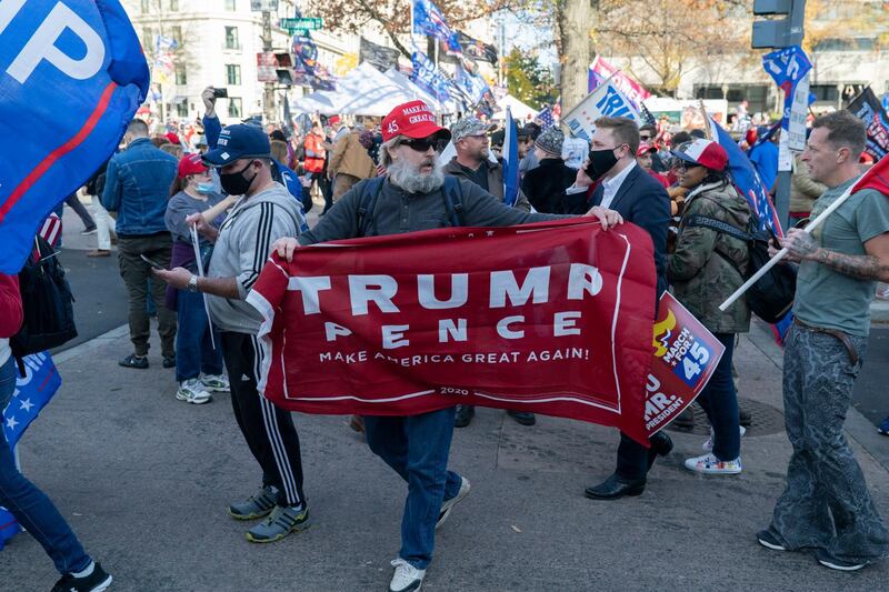 Trump supporters demonstrate as the motorcade carrying U.S. President Donald J. Trump drives through a rally of while departing the White House, Washington DC.  EPA