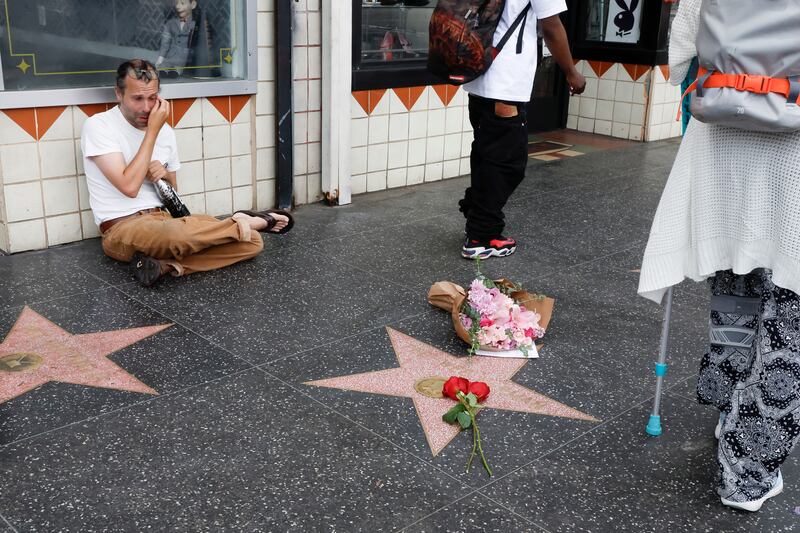 Ryan McDuffie cries next to the Hollywood Star of Pee-wee Herman, a character played by actor Paul Reubens, who has died aged 70, in Los Angeles. EPA