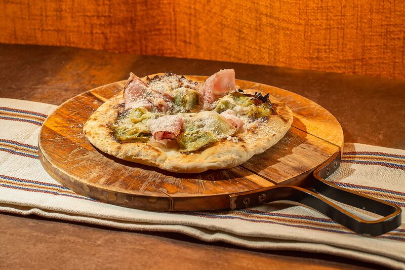 The pizzetta, with tomato, Reggiano vacche rosse cheese and ventricina sausage, is a worthy main dish. Photo: Toto Abu Dhabi