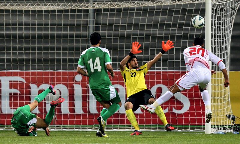 Ali Salem (R) of UAE head the ball in front of Iraq's goalkeeper during the 21st Gulf Cup's final between United Arab Emirates (UAE) and Iraq on January 18, 2013 in Manama. United Arab Emirates won 2-1 against  Iraq.  AFP PHOTO/MARWAN NAAMANI
 *** Local Caption ***  291285-01-08.jpg