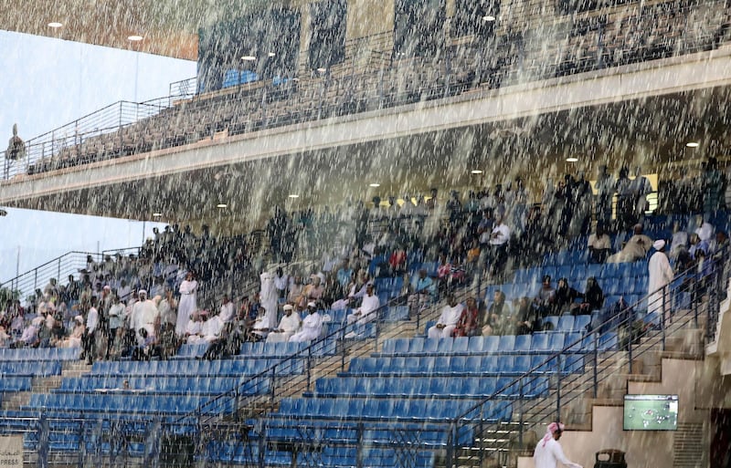 ABU DHABI , UNITED ARAB EMIRATES , November 25  – 2018 :- Spectators watching the horse race during the rain at the Abu Dhabi Equestrian Club in Abu Dhabi. ( Pawan Singh / The National ) For News/Instagram 