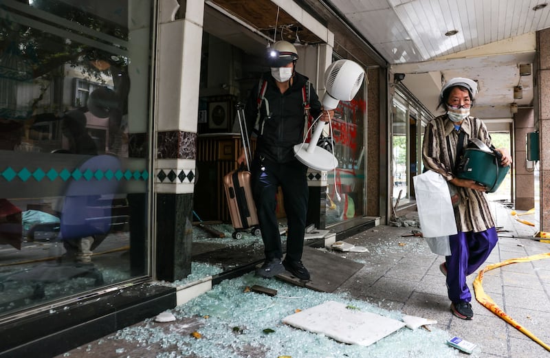 Residents salvage their belongings from their damaged building after the earthquake in Hualien, Taiwan. At least 10 people were killed and nearly 1,100 injured in the 7.4-magnitude quake on April 3. AFP