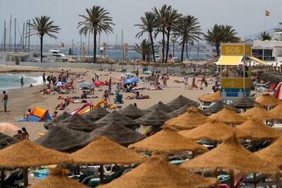 People cool off on a beach in Marbella, Spain July 9, 2021. Reuters