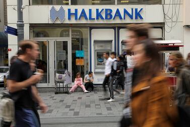 People walk past by a branch of Halkbank in central Istanbul, Turkey, October 16, 2019. REUTERS/Huseyin Aldemir/File Photo