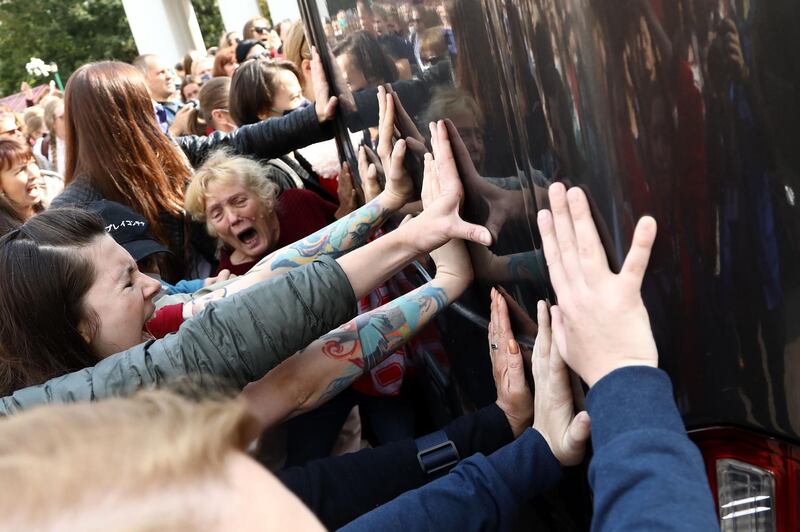 Women block a police bus during a rally to protest against the presidential election results in Minsk. Belarus. AFP