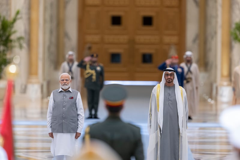 President Sheikh Mohamed and Narendra Modi, Prime Minister of India, stand for the national anthem at Qasr Al Watan. Abdulla Al Neyadi /  UAE Presidential Court