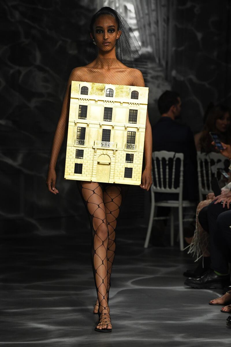 The final look of the Christian Dior Fall-Winter 2019/2020 Haute Couture collection, that featured a gold model of Dior&#39;s famous&nbsp;30 Avenue Montaigne building.&nbsp;AFP
