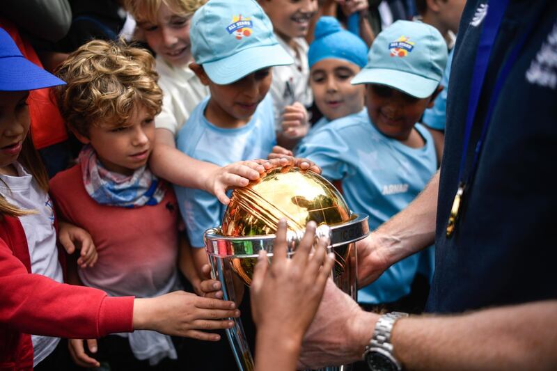 School children touch the Cricket World Cup trophy during the England ICC World Cup Victory Celebration at The Kia Oval in London, England. Getty Images