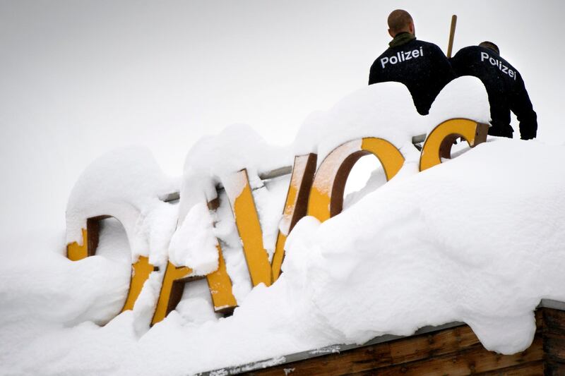 Swiss police stand on the roof of the Kongress hotel next to the Congress Center ahead of the 48th annual meeting of the World Economic Forum, WEF, in Davos, Switzerland, Monday, Jan. 22, 2018. The meeting brings together entrepreneurs, scientists, chief executive and political leaders in Davos from January 23 to 26. (Laurent Gillieron/Keystone via AP)