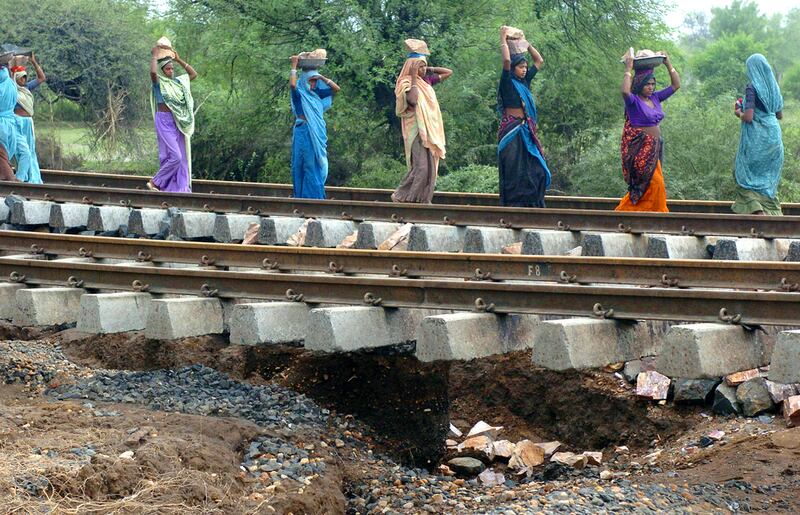 Workers repair railway tracks washed away by floods in the western state of Gujarat. Raveendran / AFP