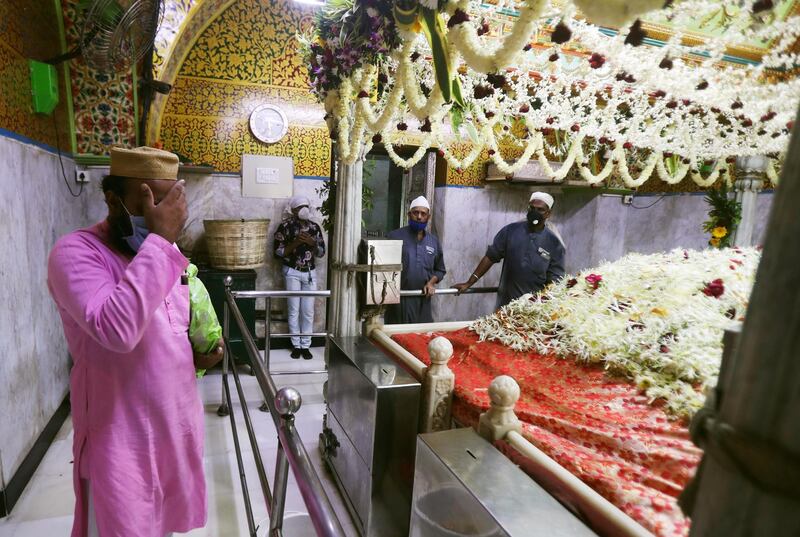 A man wearing mask offers prayers at the shrine of Makhdoom Ali Mahimi, an ancient Muslim scholar and saint in Mumbai, India. Religious places across the Maharashtra state reopened for devotees on Monday after remaining closed due to the COVID-19 pandemic. A country of nearly 1.4 billion people, India is the world's second most coronavirus affected country after the United States. AP Photo