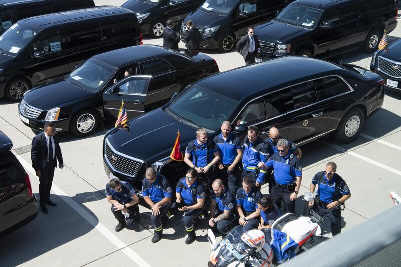 Geneva police motorbike drivers pose for pictures in front of the Biden motorcade at the airport in Geneva. EPA