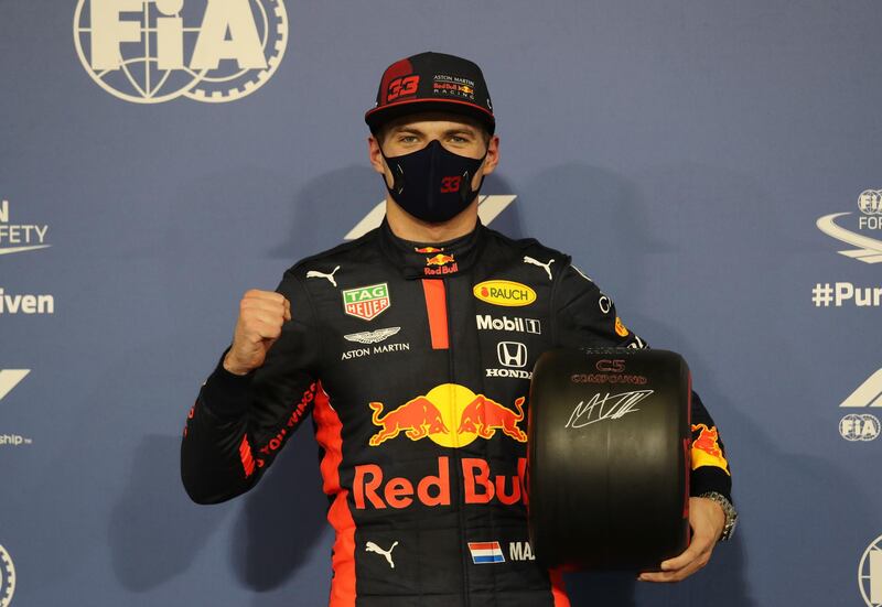 Red Bull's Max Verstappen poses with a wheel as he celebrates after qualifying in pole position. Reuters