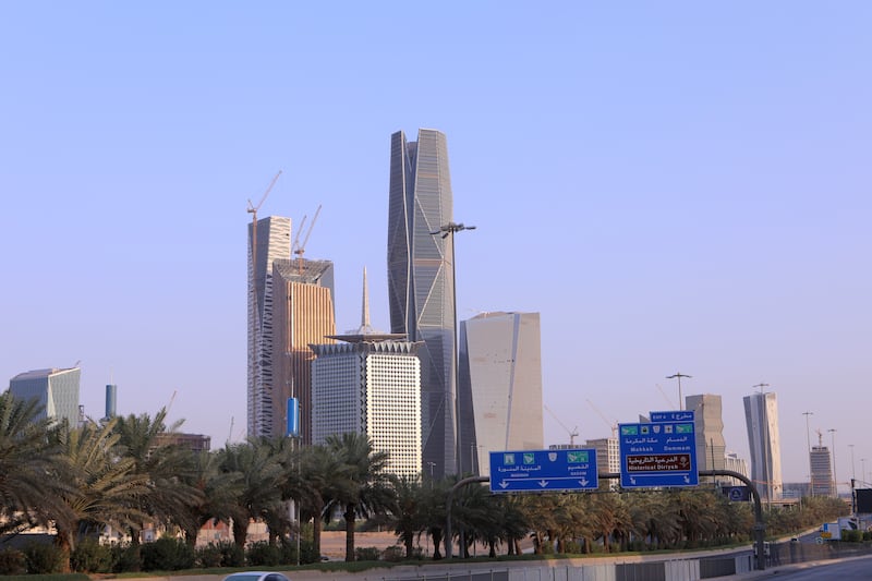 Palm trees line a highway near skyscrapers including the Capital Market Authority (CMA), center, tower at the King Abdullah Financial District (KAFD) in Riyadh, Saudi Arabia. Getty