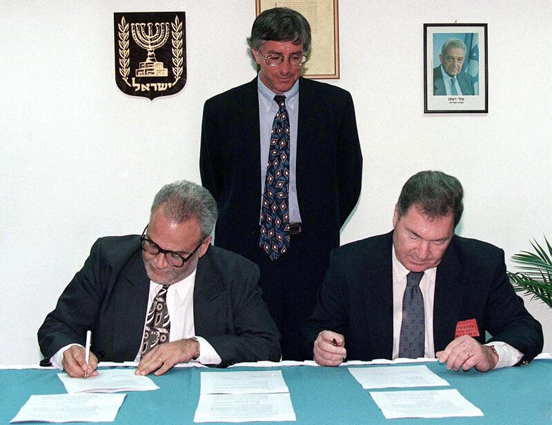 United States' special envoy Dennis Ross looks on as Saeb Erekat (L), the chief Palestinian negotiator, and Dan Shomron, the chief Israeli negotiator, initial the documents that bring to a conclusion the long-delayed and overdue Israeli troop redeployment in the West Bank city of Hebron. Palestinian President Arafat and Israeli Prime Minister Netanyahu shook hands on the deal, and now both sides will take the agreement to their respective cabinets for approval. The troop redeployment will take place within ten days.

MIDEAST
