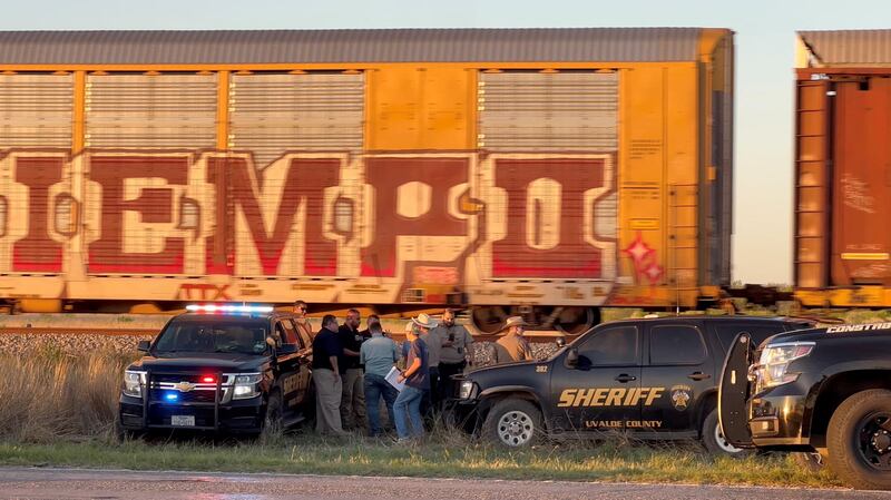 Police officers gather near a railway line in Uvalde, Texas, where a group of migrants was discovered on board a freight train. Reuters