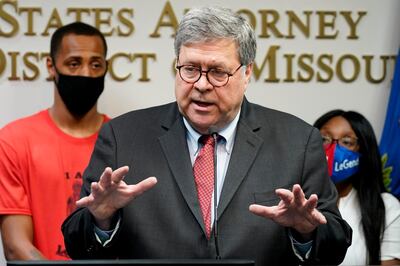 Attorney General William Barr talks to the media during a news conference about Operation Legend, a federal task force formed to fight violent crime in several cities, Wednesday, Aug. 19, 2020, in Kansas City, Mo. Behind Barr is Raphael Taliferro, and Charron Powell, the parents of 4-year-old LeGend Taliferro who was shot and killed while asleep in his bed and became the namesake for Operation Legend. (AP Photo/Charlie Riedel)