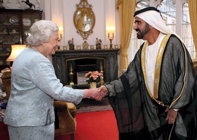A handout picture from the media office of Vice President, Prime Minister and Defence Minister of the UAE and Ruler of Duabi, Sheikh Mohammad bin Rashid al-Maktoum (R), shows the latter shaking hands with Britain's Queen Elizabeth II during a meeting in Windsor Castle in London on November 23, 2009. AFP PHOTO/HO/ SHEIKH MOHAMMAD AL-MAKTOUM MEDIA OFFICE  == RESTRICTED TO EDITORIAL USE == (Photo by SHEIKH MOHAMMAD AL-MAKTOUM OFFIC / AFP)