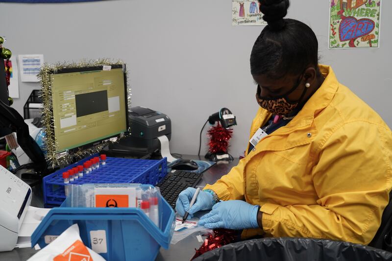 A worker at Mako Medical Laboratories registers a PCR test. Willy Lowry / The National