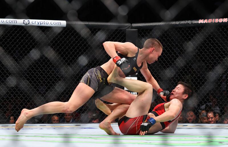 Rose Namajunas punches Zhang Weili. Reuters