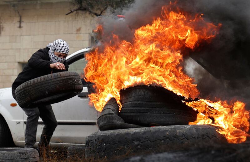 A Palestinian youth burns tyres during confrontations with Israeli security forces. AFP