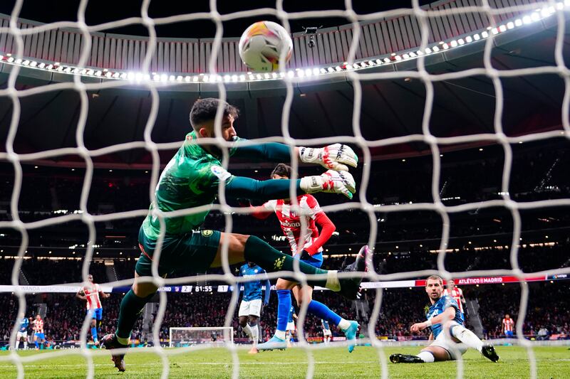 Atletico Madrid's Joao Felix scores past Alaves goalkeeper Fernando Pacheco. AP