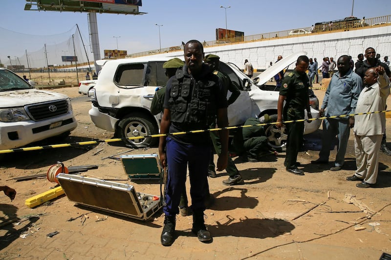Security personnel stand near a car damaged after an explosion targeting the motorcade of Sudan's Prime Minister Abdallah Hamdok near the Kober Bridge in Khartoum, Sudan. Reuters