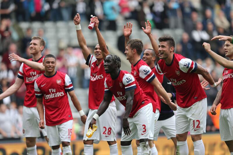 Arsenal players celebrate their victory after the final whistle in the English Premier League football match between Newcastle United and Arsenal at St James' Park in Newcastle Upon Tyne, northeast England, on May 19, 2013. Arsenal won the race for fourth place in the Premier League with a 1-0 victory at Newcastle.  AFP PHOTO / IAN MACNICOL

RESTRICTED TO EDITORIAL USE. No use with unauthorized audio, video, data, fixture lists, club/league logos or “live” services. Online in-match use limited to 45 images, no video emulation. No use in betting, games or single club/league/player publications.
 *** Local Caption ***  152716-01-08.jpg