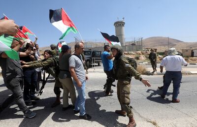 Tension between Israeli soldiers and Palestinian protesters trying to cross the Tayaseer checkpoint on Monday, where Palestinian medical sources say 25 people were wounded during clashes. EPA