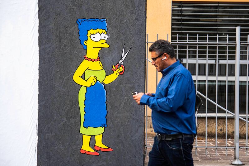 A mural in Milan, Italy, shows Marge Simpson, a character in the animated sitcom 'The Simpsons', cutting her hair in protest over the death of Amini. EPA