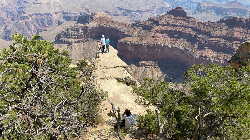 A couple has their photo taken close to the edge of the Grand Canyon in the southern US. AFP