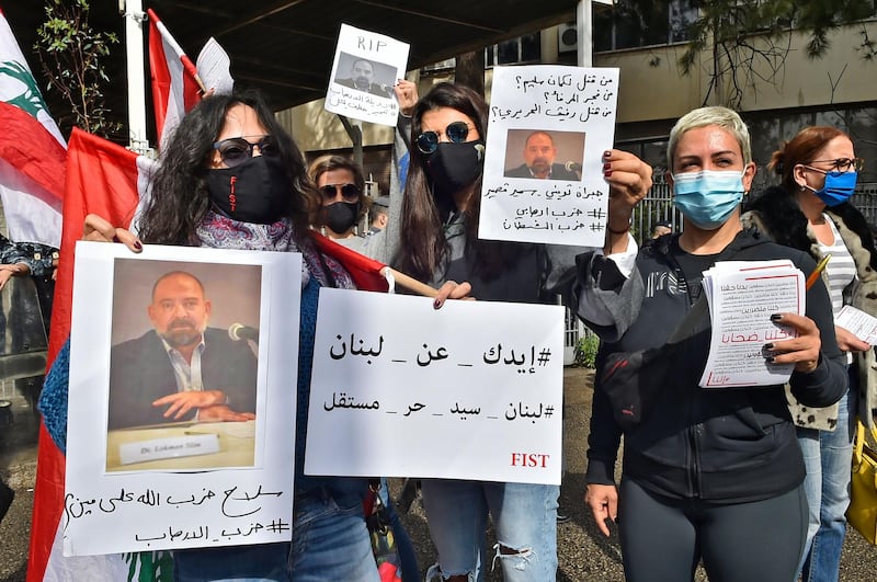 Protesters hold pictures of slain prominent Lebanese activist and intellectual Lokman Slim,  during a rally in front of the Justice Palace in the capital Beirut. AFP