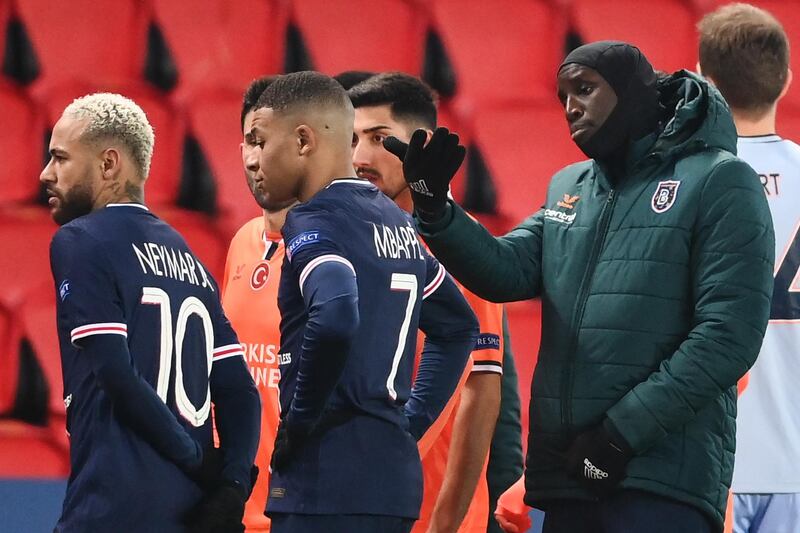 Istanbul Basaksehir's Demba Ba (R) gestures past Paris Saint-Germain's Neymar and Kylian Mbappe after the game was suspended amid allegations of racism by one of the match officials. AFP