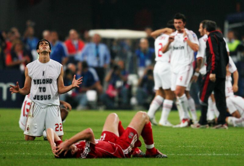 ATHENS, GREECE - MAY 23:  A dejected Xabi Alonso of Liverpool lies on the pitch, whilst Kaka (L) of Milan celebrrates his teams 2-1 victory  during the UEFA Champions League Final match between Liverpool and AC Milan at the Olympic Stadium on May 23, 2007 in Athens, Greece.  (Photo by Jamie McDonald/Getty Images)