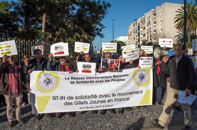 People hold placards and shout slogans during a solidarity demonstration of the 'Gilets Jaunes' or 'Yellow Vests' movement, in front of the French Embassy building in Rabat, Morocco.  EPA