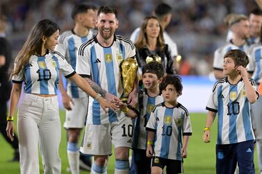 Argentina's forward Lionel Messi celebrates with his wife Antonela Roccuzzo (L) and their children Thiago (R), Mateo (C) and Ciro (2-R), during a recognition ceremony for the World Cup winning players, following the friendly football match between Argentina and Panama at the Monumental stadium in Buenos Aires on March 23, 2023.  (Photo by JUAN MABROMATA  /  AFP)