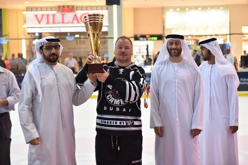 Dubai Mighty Camels ice hockey team captain Ron Murphy, centre, with the EHL Cup. Courtesy photo