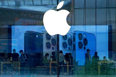 People try out the latest iPhone 13 handsets at an Apple Store in Beijing. AP 